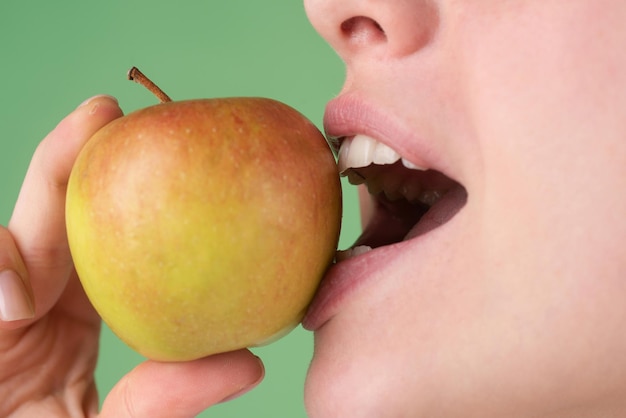 Dental Care. Healthy white teeth closeup with an apple.