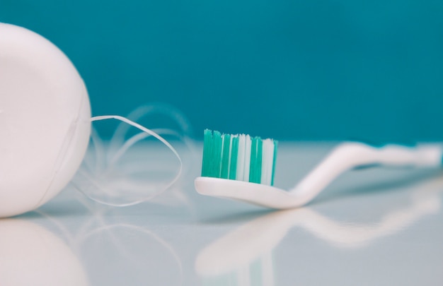 Photo dental care, oral care products close-up on a light green