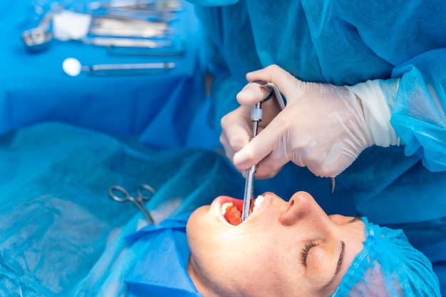 수술 전에 마취 주사를 적용하는 치과 여성 치과 의사