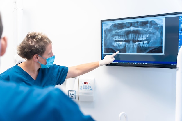 Dental clinic sitting patient talking to the dentists about the treatment that they are going to perform