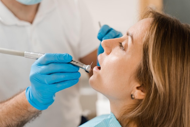 Dental drill closeup Dentist drilling teeth of woman in dentistry clinic Teeth treatment Dental filling for girl patient