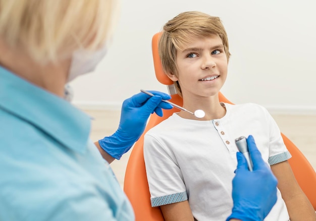 Dental examination of blond boy is