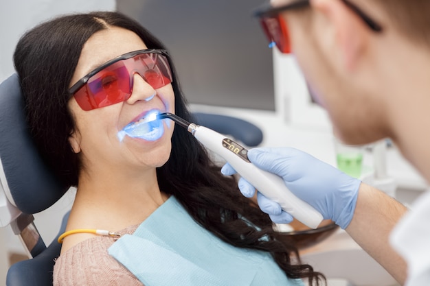 Photo dental filling with uv lamp for a senior female patient