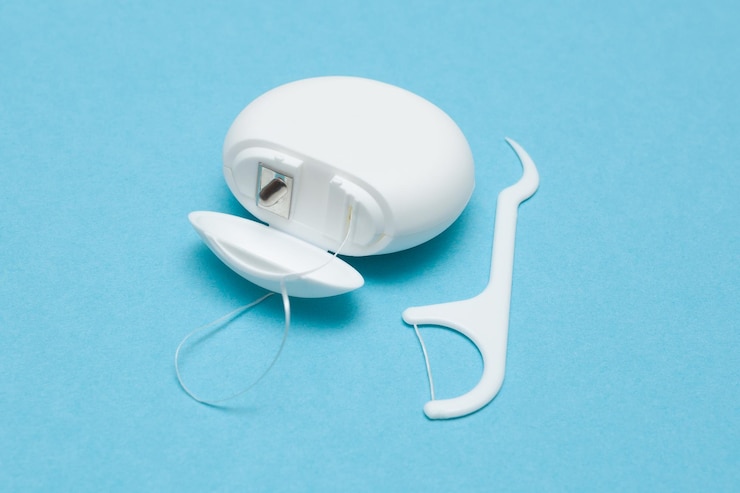 Photo dental floss on a blue background caring for dental health oral hygiene