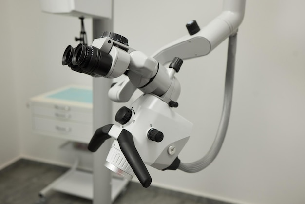 Dental microscope on the background of modern dentistry Medical equipment Dental operating microscope with rotary double binocular