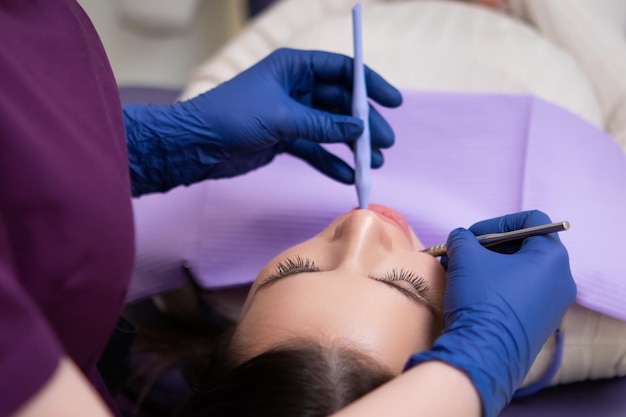 During a dental office visit the dentist is examining the patients teeth