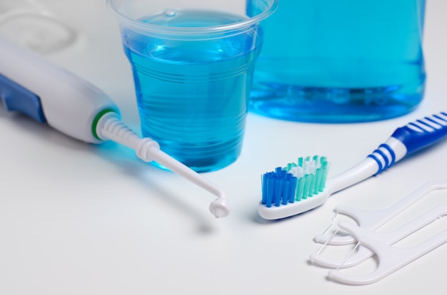 Dental oral irrigator, toothbrush, dental floss, mouthwash. 