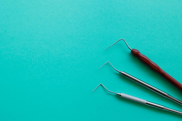 Dental probe instruments on light green background