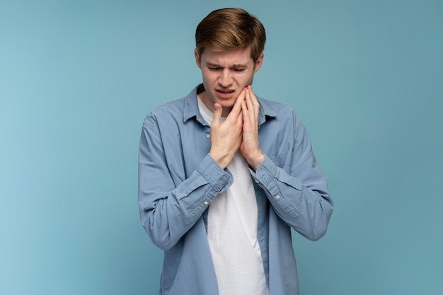 Dental problems Portrait of unhealthy man pressing sore cheek