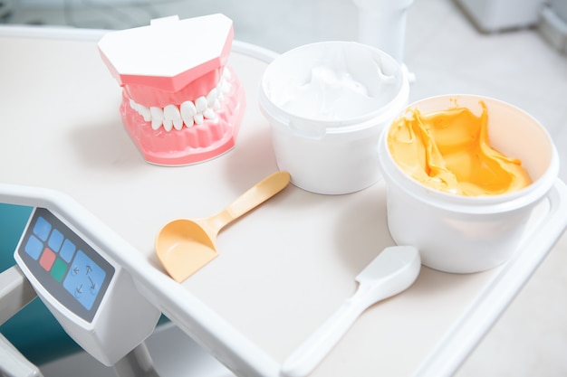 Dental putty and human jaw model on the table at dental clinic