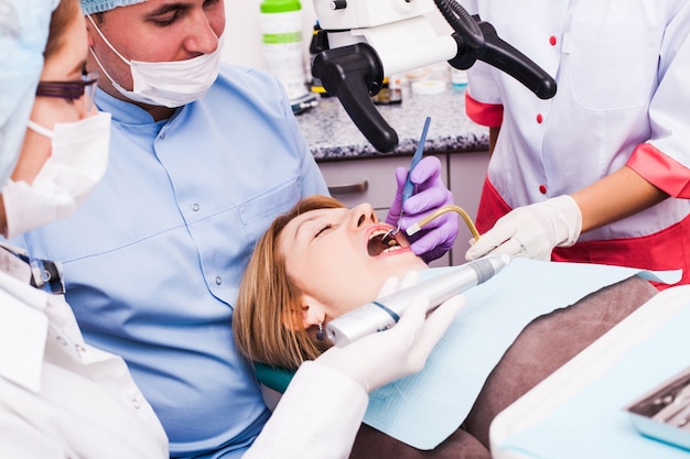 Dental surgery procedure in dental office, medical doctors team is doing dental operation