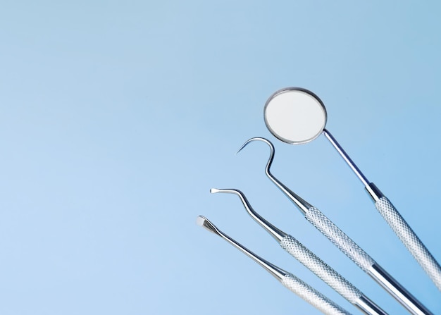 Dental tools on blue background top view