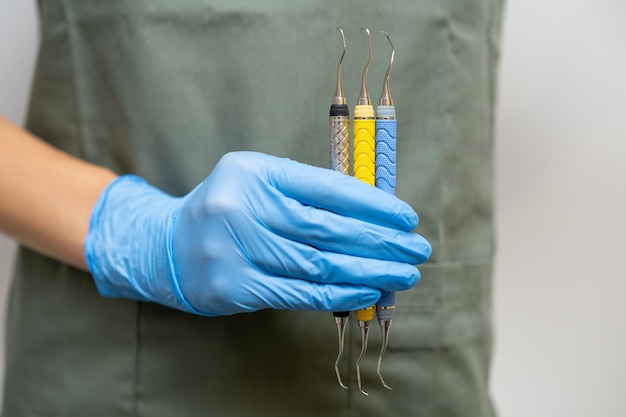 Dental tools or explorer in dentists hand in rubber gloves