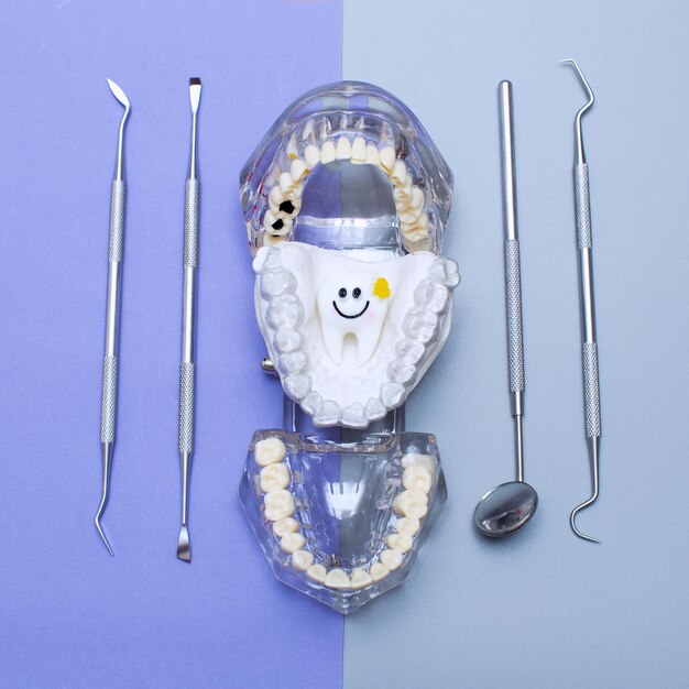 Dental tools and model of teeth on a blue background dental care concept invisible braces