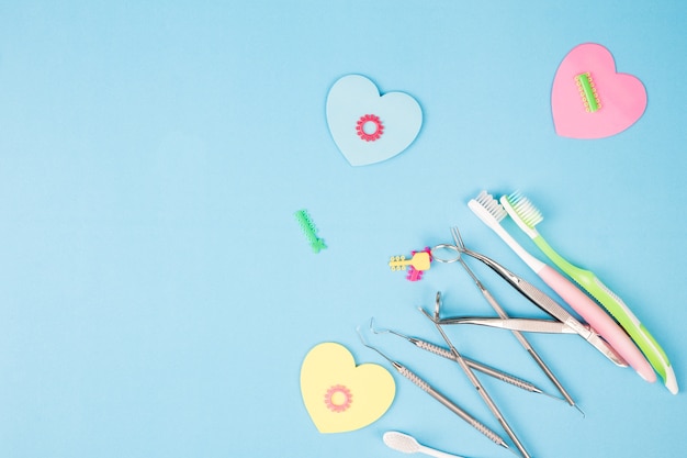 Dental tools use for dentist on the blue background, flat lay, top view.