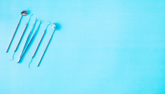 Dental tools use for dentistonblue, flat lay, top view.