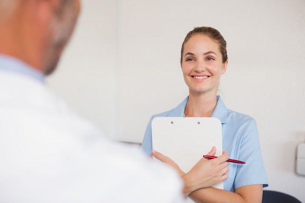 Dentist and assistant facing each other