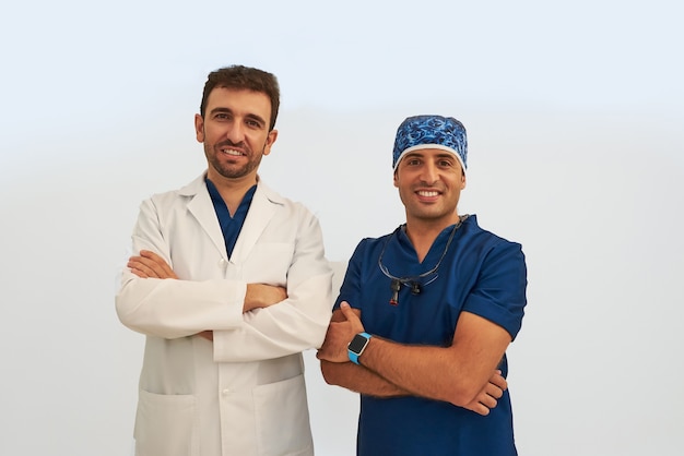 Dentist and an assistant smiling.