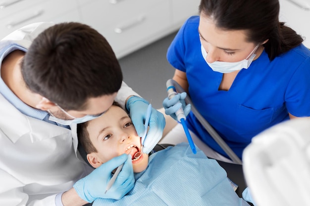 dentist checking for kid teeth at dental clinic