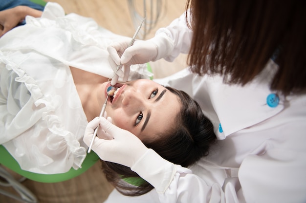 Dentist checking patient woman teeth