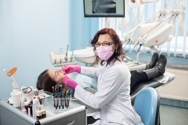 Dentist checking up patient teeth