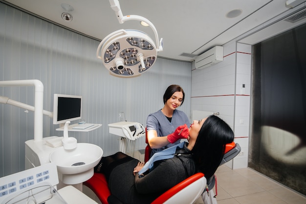 The dentist conducts an examination and consultation of the patient. Dentistry.