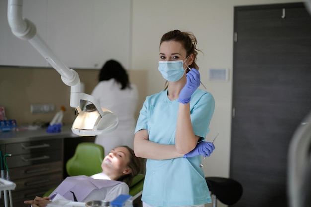 Dentist in dental office talking with female patient and preparing for treatment