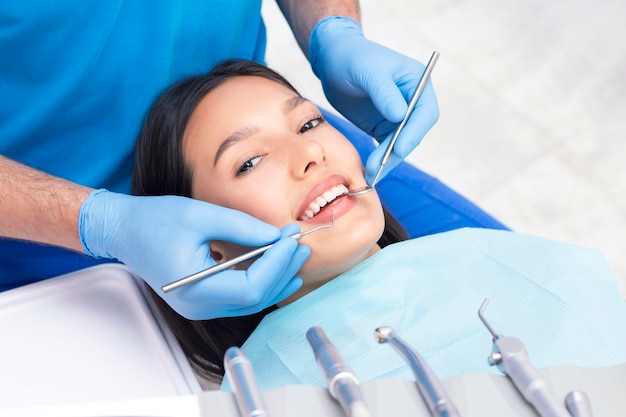 Dentist examines the patients teeth at the dentist. close up