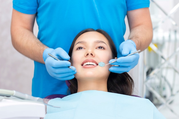 dentist examines the patients teeth at the dentist.