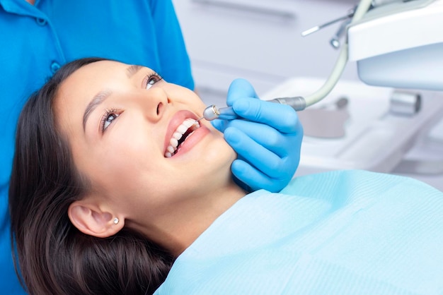 Dentist examines the patients teeth at the dentist.