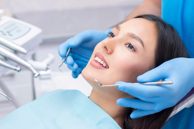 Dentist examines the patients teeth at the dentist.