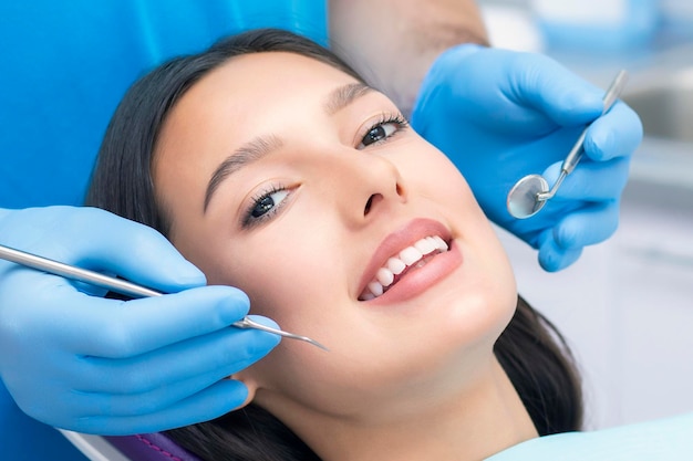 Dentist examines the patients teeth at the dentist