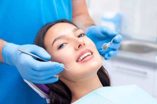 Dentist examines the patients teeth at the dentist