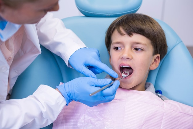 Dentist examining boy at clinic