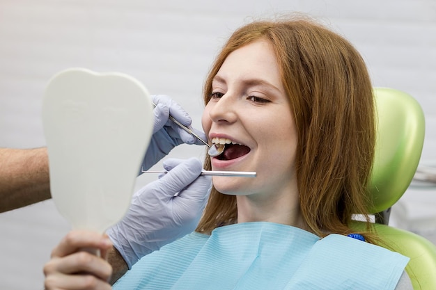 Dentist examining girl's teeth in clinic Dental problem Healthy Smile