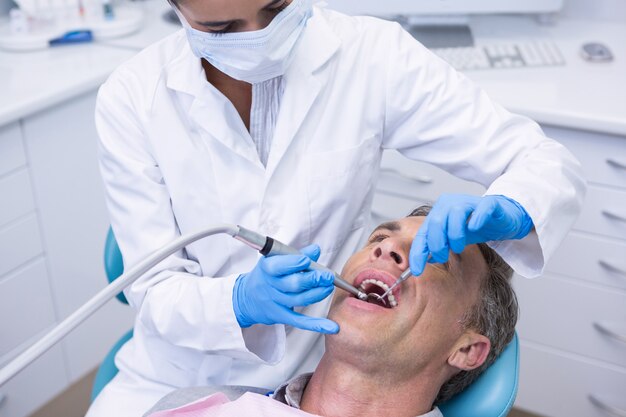 Dentist examining patient at clinic