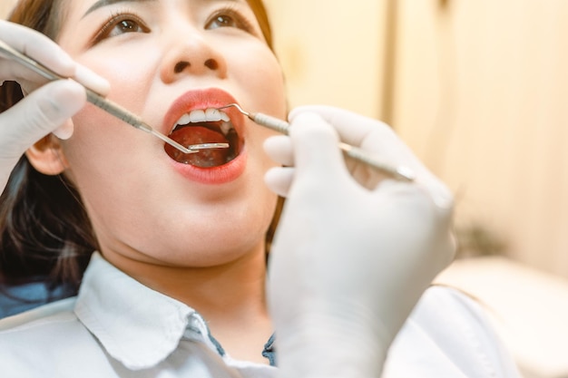 Dentist examining teeth patients in clinic for better dental health and a bright smileDentist checking teeth with toolsDentist tools and equipment