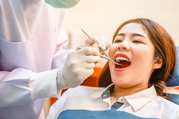 Dentist examining teeth patients in clinic for better dental health and a bright smileDentist is scraping limestoneDentist tools and equipment