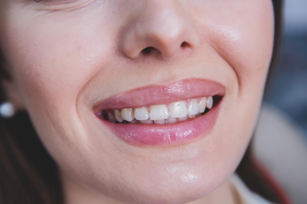 Photo dentist examining teeth of a young woman patient in a dental clinic dentistry concept