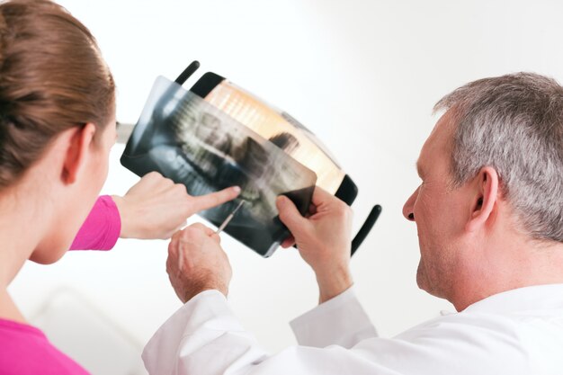 Dentist explaining x-ray to patient