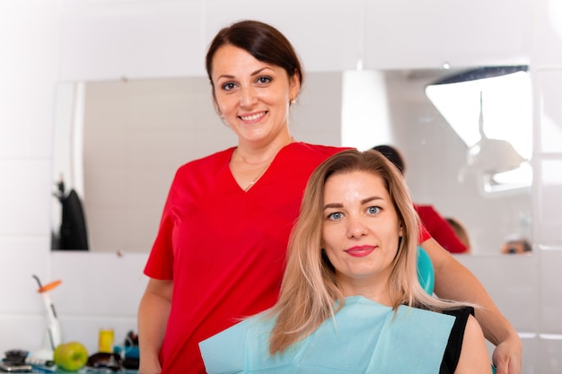 The dentist and her happy patient smiling. Reception at the dentist, healthy teeth, happy patient, beautiful teeth.