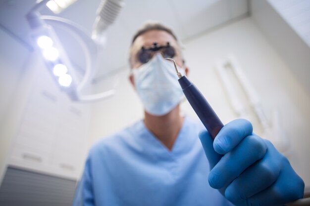 Dentist holding dental tool