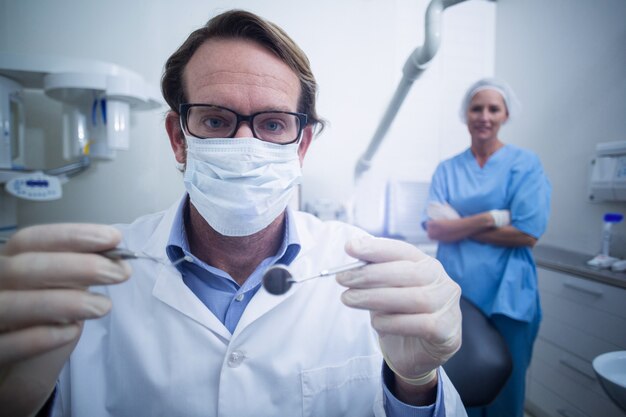 Dentist holding dental tools