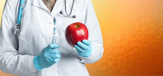 Dentist holding a ripe apple