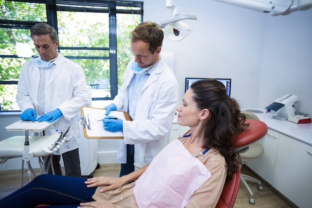 여성 환자와 상호 작용하는 치과 의사