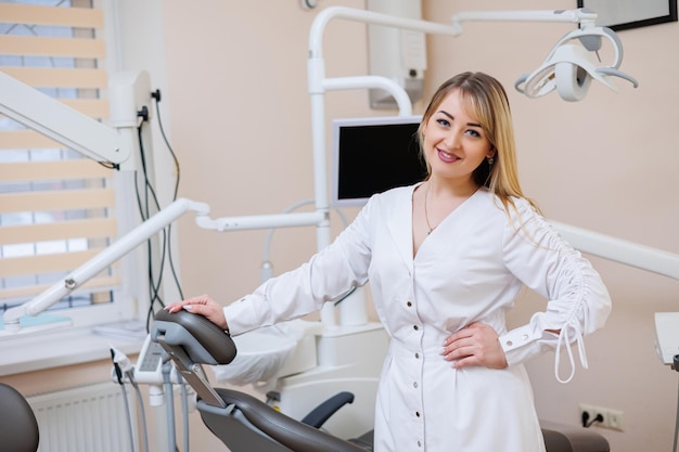 The dentist is in his dental office Dentist woman in a white coat Dental office