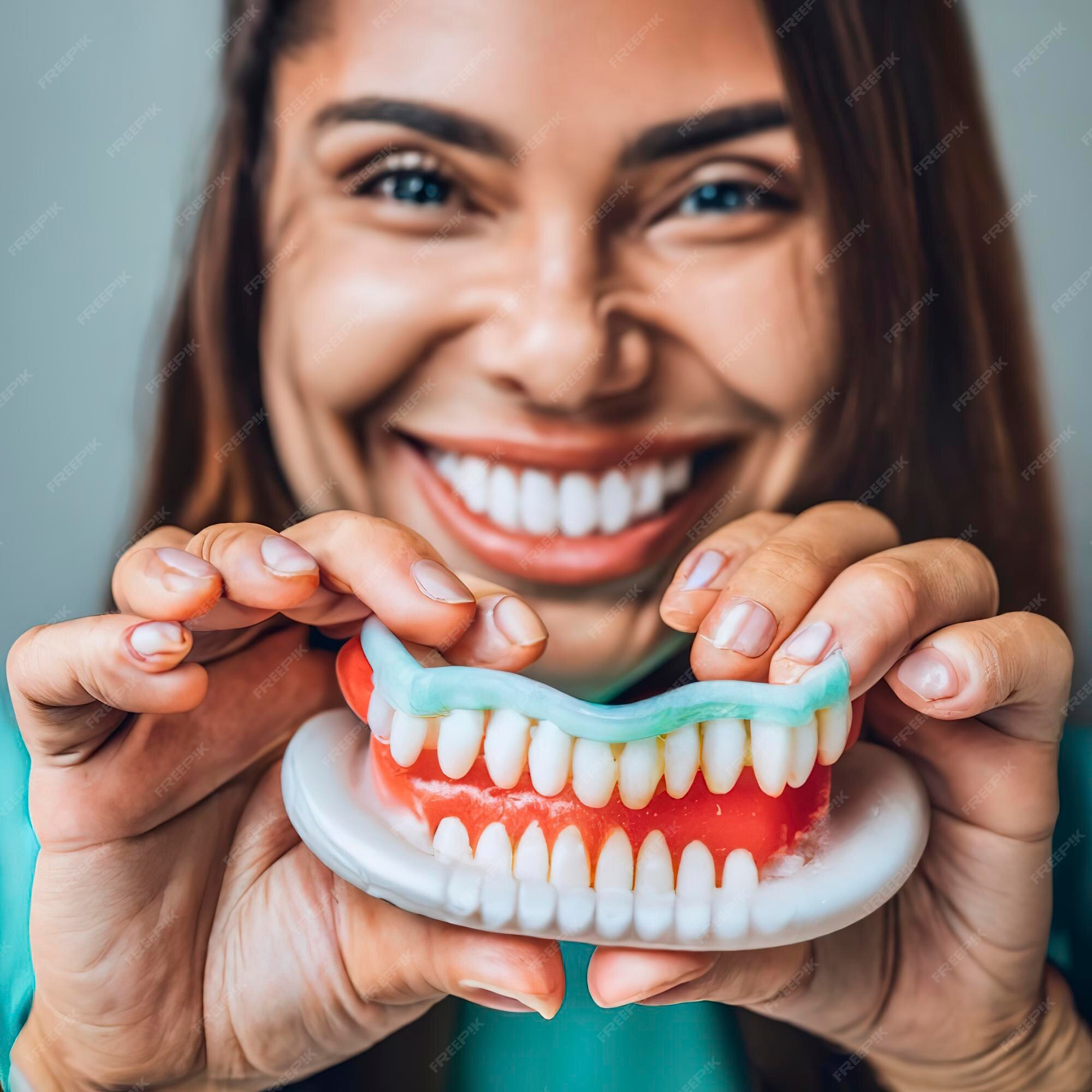 Premium AI Image Dentist is holding dentures jaw showing how to brush