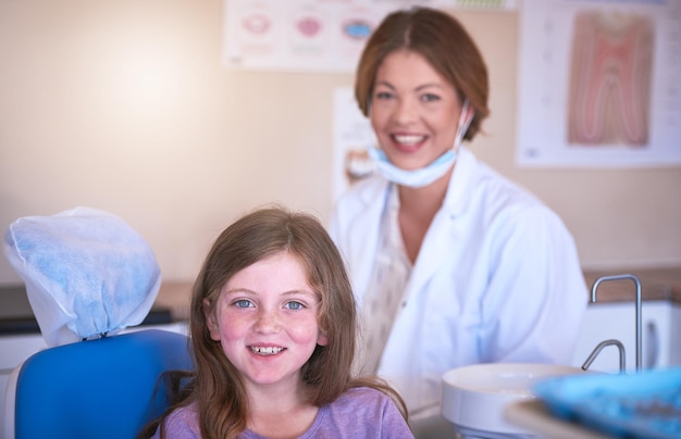 dentist kid and portrait with doctor for dental health or cavity treatment for oral hygiene or teeth cleaning pediatric clinic and happy girl child with woman and smile for medical consultation