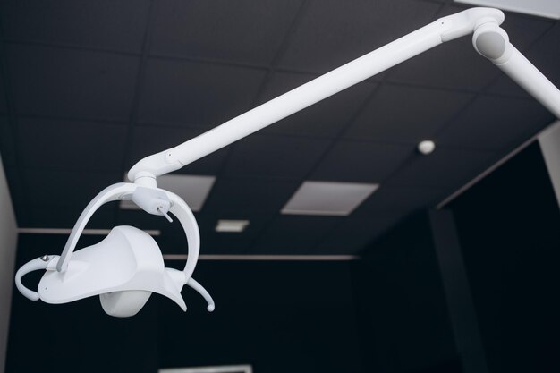 A dentist light or dental lamp against the ceiling of the room