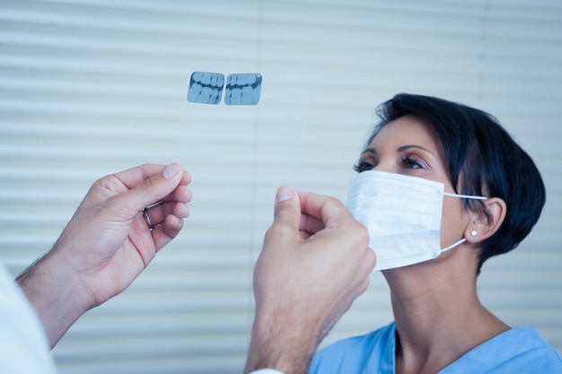 Dentist looking at x-ray